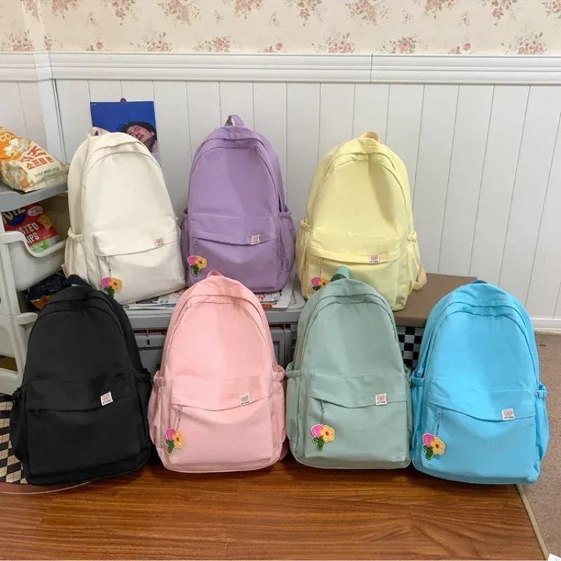 nouveau sac à dos imperméable en nylon pour femmes, sac de voyage, cartable pour adolescentes, sac à livres de couleur unie