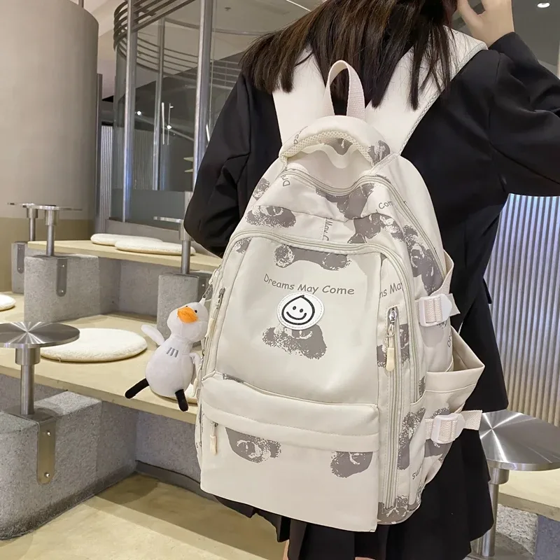 sac dos nylon blanc rouge bleu patchwork bandoulière arquée poche ouverte informatique classement souple voyager école collège