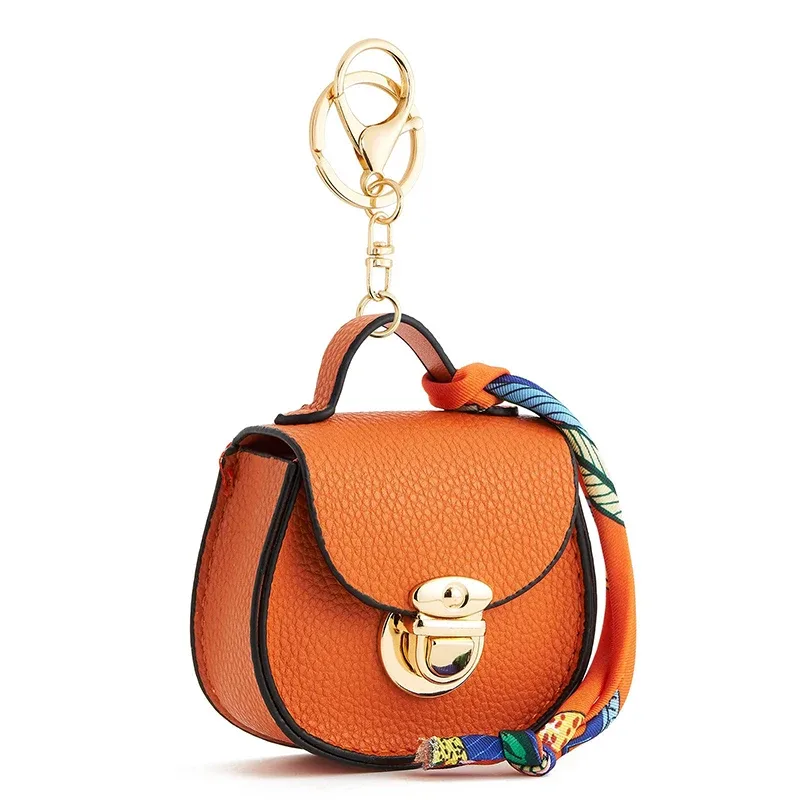 Pochette porte-clés multifonctionnelle et portable, tendance et polyvalente, en forme de selle, avec porte-monnaie et étui de rangement pour écouteurs sans fil.