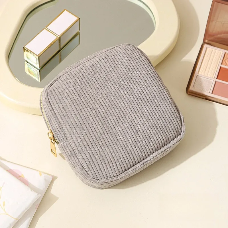 pochette polyester beige rayures verticales cosmétiques serviettes hygiéniques voyage femmes organisateur tranche usage polyvalent